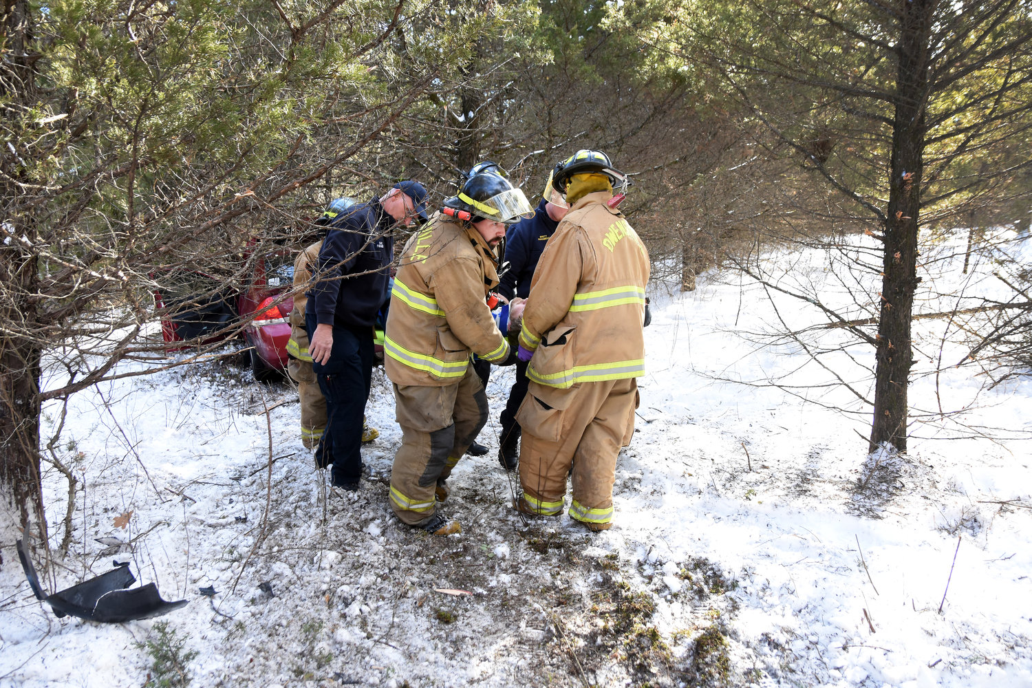 FIREMEN AND ambulance personnel carry out an injured Sullivan man following the crash.